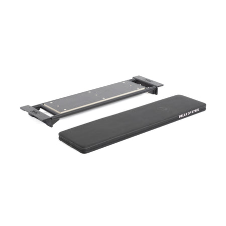 A rectangular black workout pad with "Bells of Steel" branding sits beside the Utility Seat for Hydra/Manticore, which features black end pieces, on a white background.