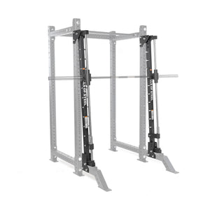 The Bells of Steel Smith Machine Rack Attachment, in silver and black, is mounted on a gray power rack frame. Its barbell glides smoothly along vertical guide rails for safe, controlled lifting within the Smith machine structure.