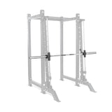 A Bells of Steel Smith Machine Rack Attachment is mounted on a 3x3 rack in faded gray, highlighting the silver barbell with black weight plates. The rack's multiple adjustment holes allow for easy power rack upgrades.