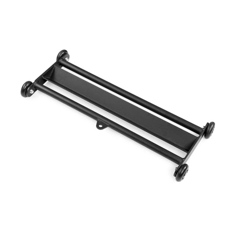 The Bells of Steel Glute Ham Slider is a black metal rectangular dolly with four caster wheels and side rails, designed for easy object transport and doubles as a slider for hamstring or ab exercises.