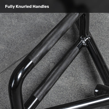 Close-up of a Bells of Steel Open Trap Bar / Hex Bar with fully knurled handles, resting on a gray textured floor. The text "Fully Knurled Handles" appears at the top.
