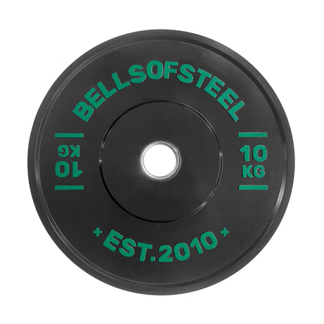 The Bells of Steel Dead Bounce Conflict Bumper Plate is a black 10 kg plate made from durable virgin rubber with green “BELLSOFSTEEL,” “10 KG,” and “EST. 2010” text, featuring a center hole for standard barbells.